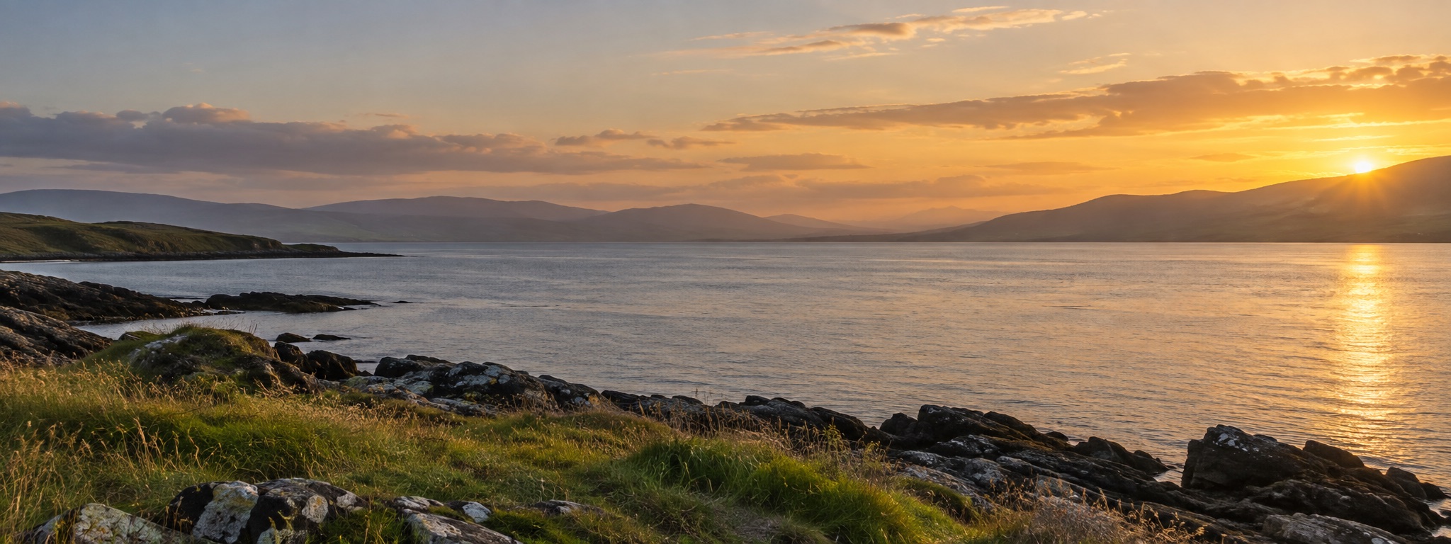 Illustrative view of a quiet Inishowen shoreline and Lough Foyle in warm evening light